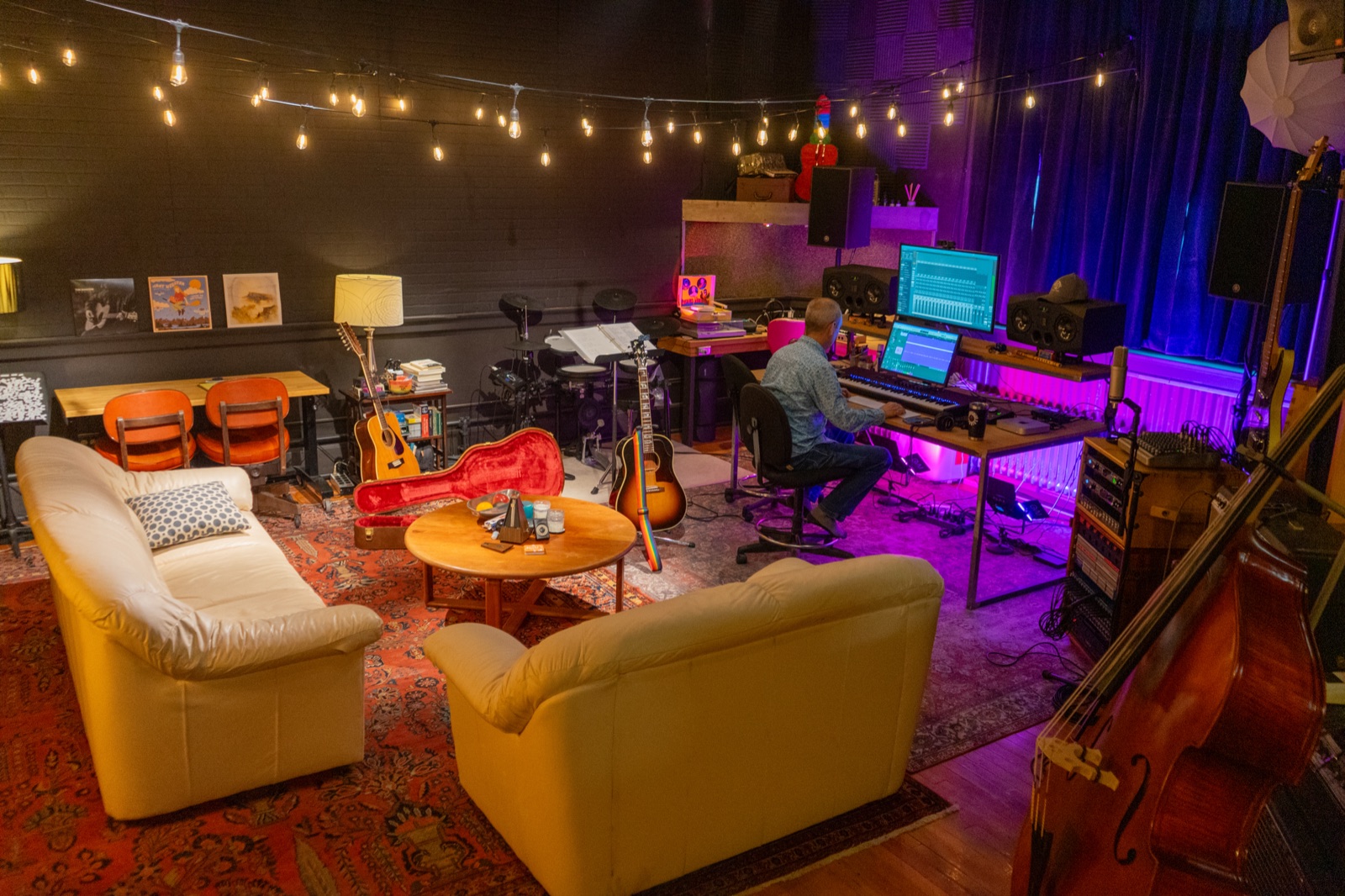 Free River Studios in Livingston, Montana — Jamey at the console, string lights overhead, instruments in the live room, vintage Persian rugs underfoot.